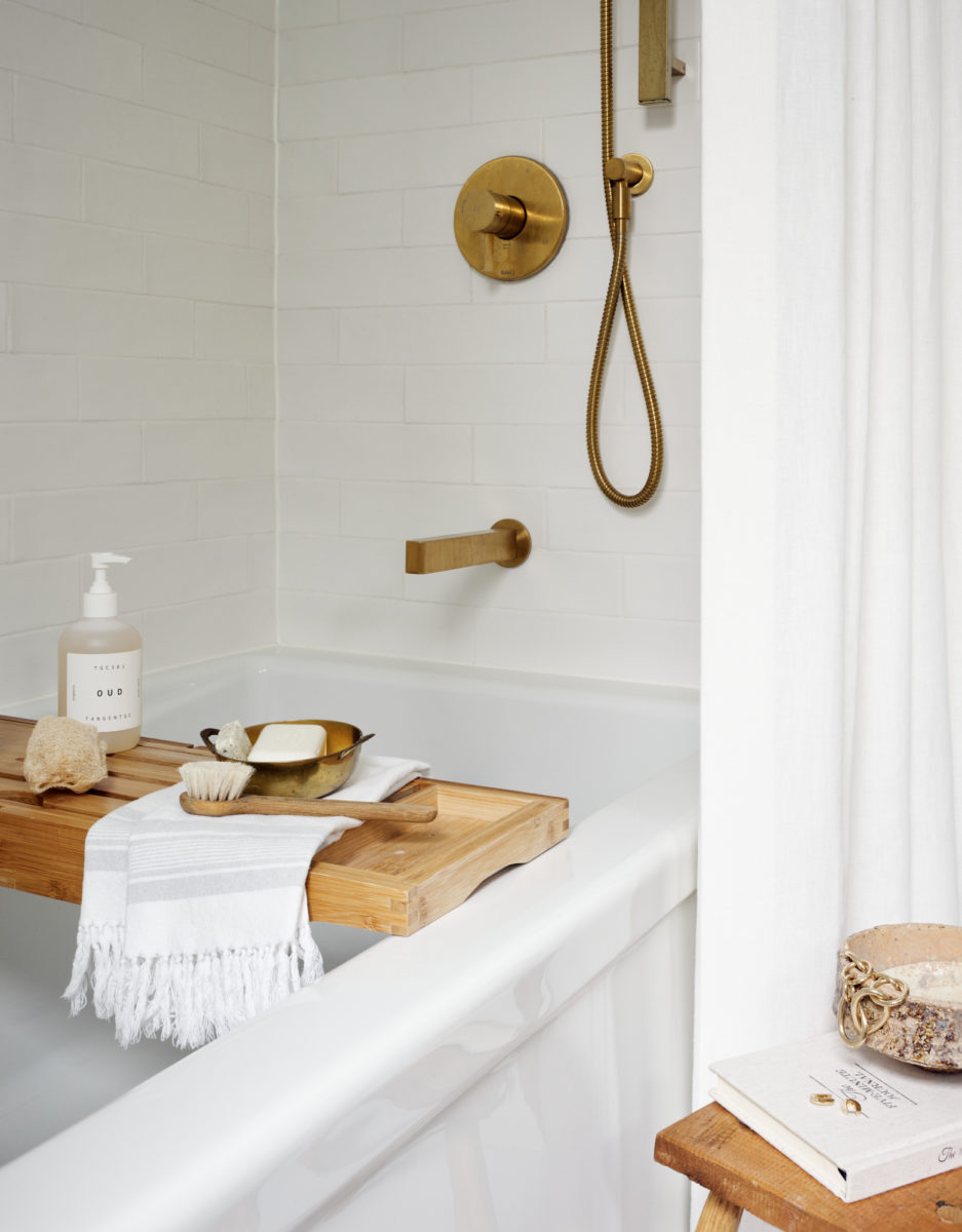 A Cozy Bathroom Accented With Gold And Wood Tones - HAVEN