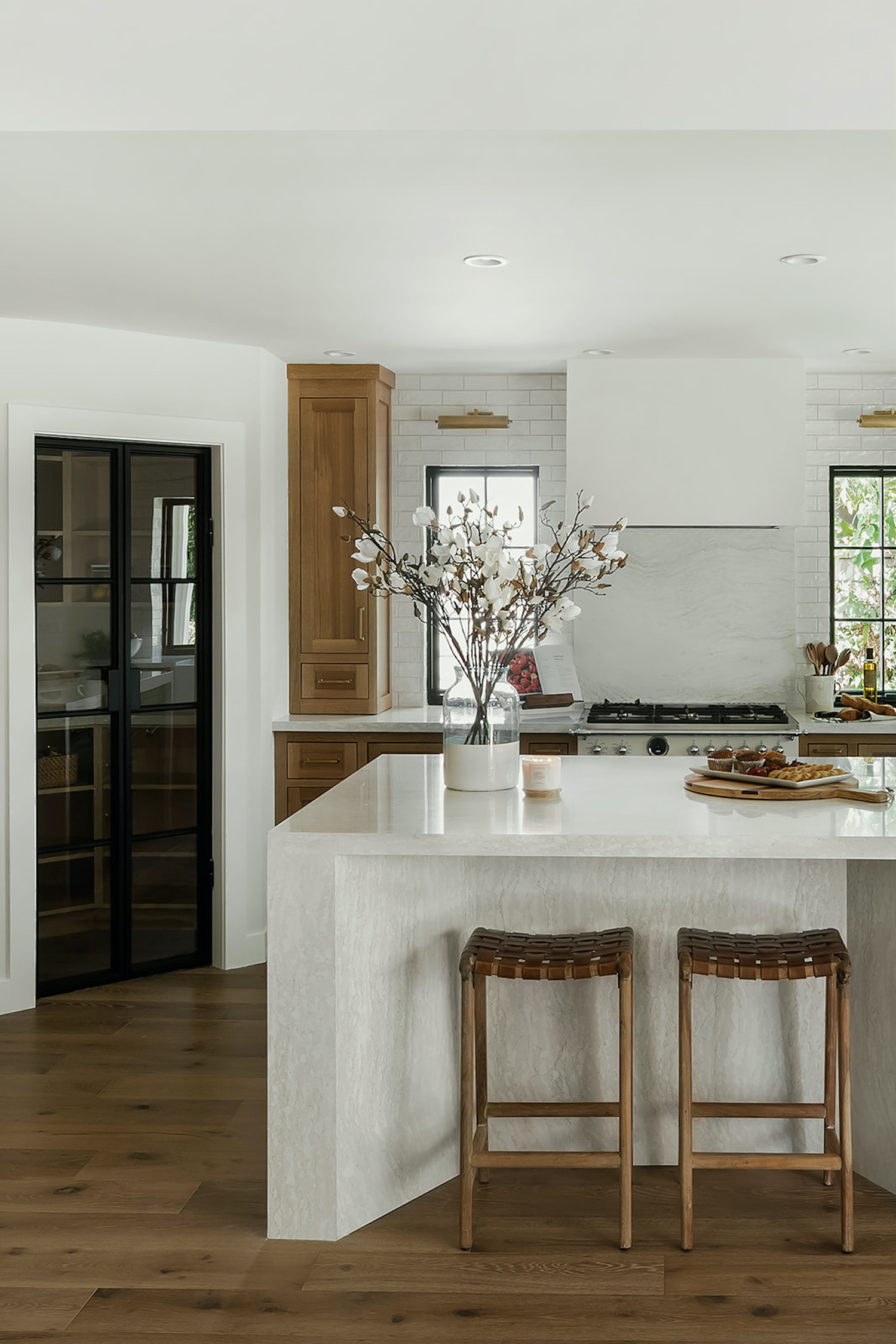 Glass Pantry Doors and Angled Waterfall Counters Spice up This Kitchen ...