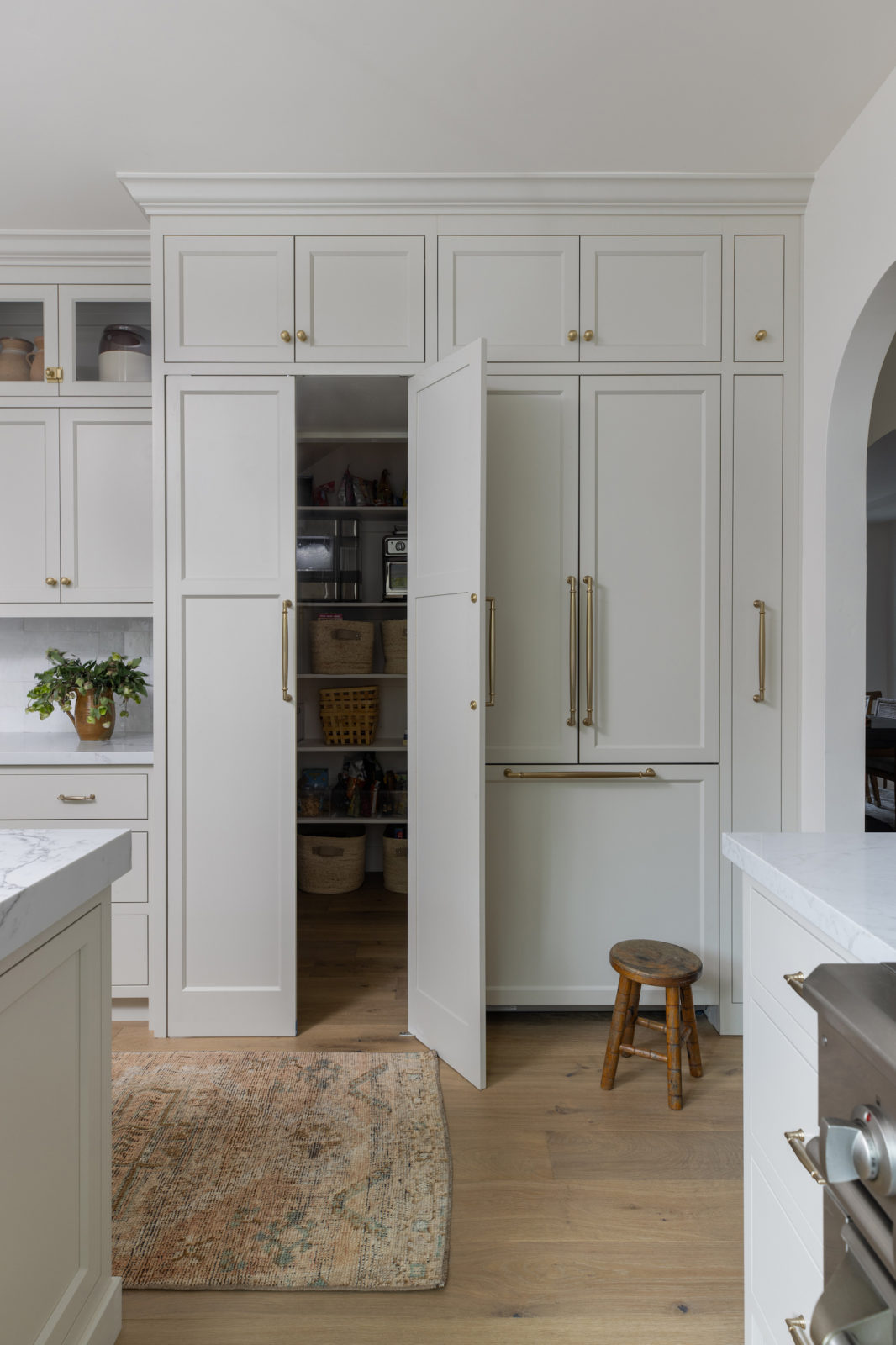 A hidden pantry brings functionality to this bright and cheery kitchen